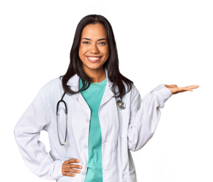 Young Filipina doctor with stethoscope in studio showing a copy space on a palm and holding another hand on waist.