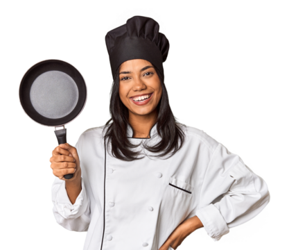 Young Filipina chef holding a cooking pan in studio