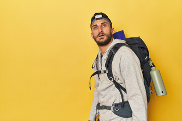 Hispanic man with backpack and headlamp