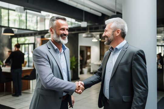 Two businessmen shaking hands in an office,