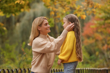Fototapeta premium Happy mother with her daughter in autumn park