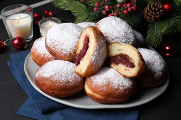 Obraz na płótnie Canvas Delicious sweet buns with jam and decor on table, closeup