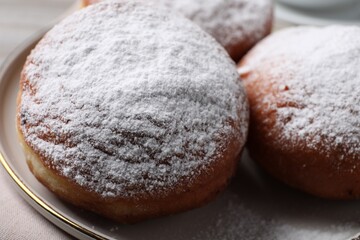 Delicious sweet buns with powdered sugar on table, closeup