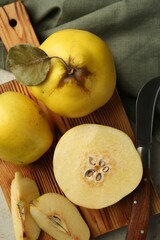Naklejka na ściany i meble Tasty ripe quince fruits and knife on grey table, flat lay