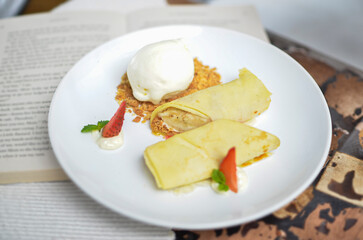 Closeup of banana strudel with ice cream on a white plate