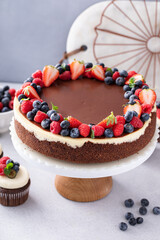 Chocolate and vanilla cheesecake topped with chocolate ganache and fresh berries