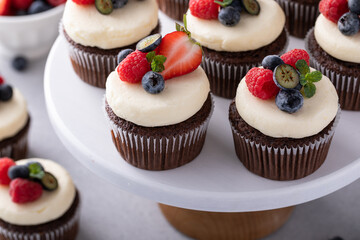 Chocolate cupcakes with vanilla frosting and fresh berries