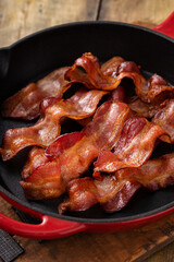 Crispy bacon in a skillet cooked and ready to eat