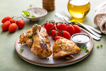 Roasted chicken thighs and drumsticks served with pesto sauce