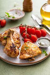 Roasted chicken thighs and drumsticks served with pesto sauce