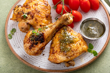 Roasted chicken thighs and drumsticks served with pesto sauce