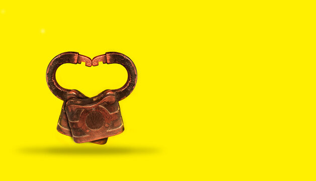 Two Locks on yellow background intertwined to Form a Heart