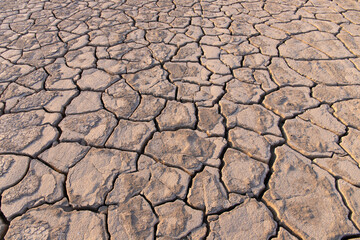 Volcanic cracks in the clay on the ground.