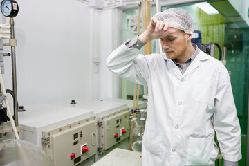 scientist feeling tired from work in testing lab
