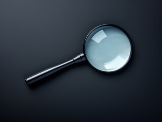 Black magnifying glass or lens, top view isolated on black background