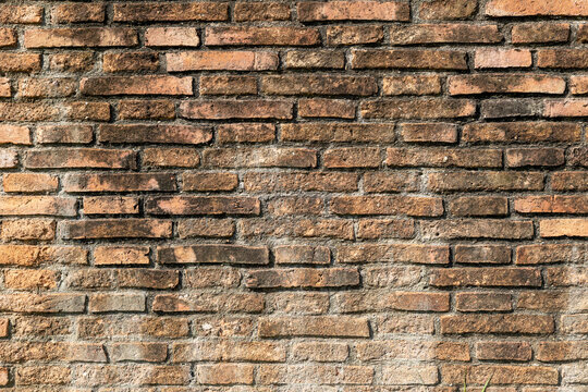 old brown red wall texture background with uneven bricks
