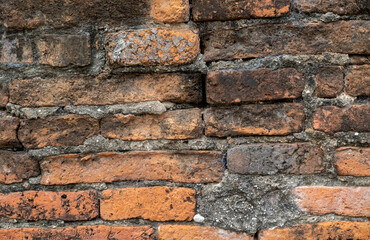 close up view of red brick wall concrete textured exterior background