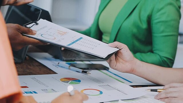 Close-up asia business people meeting plan analysis statistics brainstorm and header of team hold tablet pointing graph chart and employee take note. Finance strategy statistics success concept.