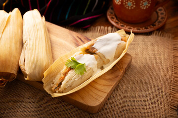 Tamales. hispanic dish typical of Mexico and some Latin American countries. Corn dough wrapped in corn leaves. The tamales are steamed.