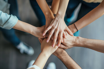 Close up top view of business people putting their hands together. Friends with stack of hands symbolizing their unity and support and teamwork. Team set up for productive work and a positive result. - obrazy, fototapety, plakaty