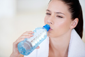 Tired, thinking or woman drinking water on break after exercise, workout or fitness training in...