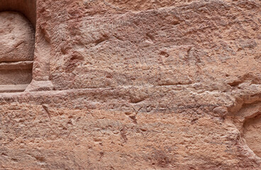 Inscriptions in the ancient Nabatean language carved into the wall of the Al Siq gorge in Nabatean Kingdom of Petra in the Wadi Musa city in Jordan