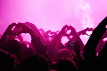 People, heart hands and pink light for music festival for love, support and care for musician....
