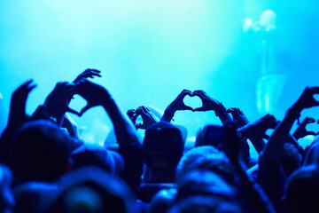 People, heart hands and crowd with blue light for music concert for love, support and care of artist. Audience, fans and nightlife together with gesture for unity, community or solidarity at festival - obrazy, fototapety, plakaty