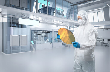 Engineer wears protective suit with silicon wafer for semiconductor manufacturing - obrazy, fototapety, plakaty