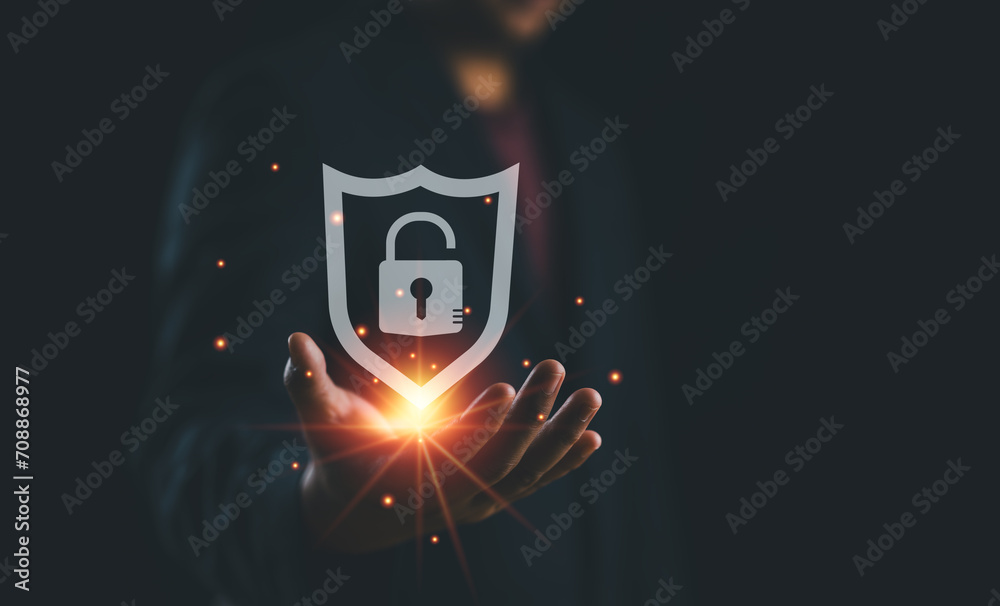 Poster Cybersecurity safe data protection business technology privacy concept. Information security system. Businessman holding shield protect security icon security on the virtual display..