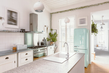 Fototapeta na wymiar Bright kitchen interior with modern white furniture, pastel mint fridge and big floor to ceiling window