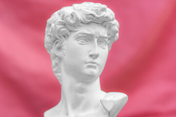  antique statue of david's head Concept of modern art and cyberpunk with pink background