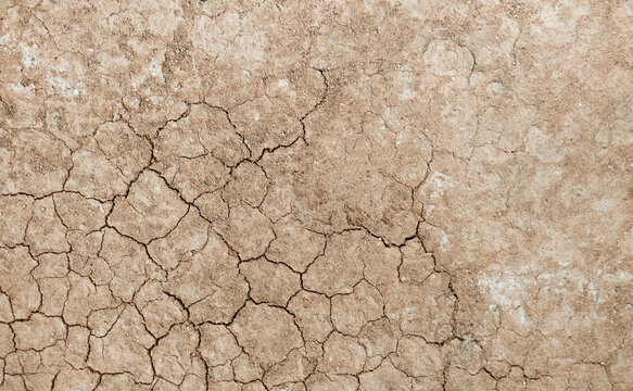 Cracked ground background in the top view for graphic design or wallpaper
