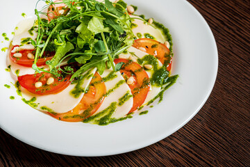 Caprese salad with mozzarella cheese, tomatoes and arugula
