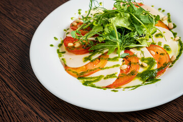 Caprese salad with mozzarella cheese, tomatoes and arugula