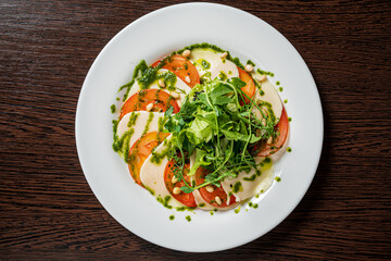 Caprese salad with mozzarella cheese, tomatoes and arugula