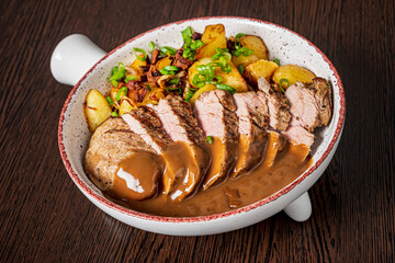 pork with baked potatoes and sauce