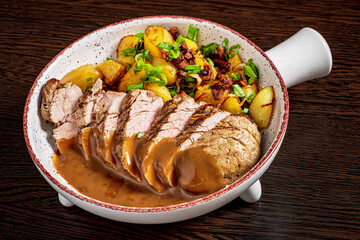 pork with baked potatoes and sauce