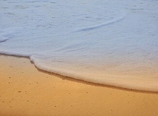 Closeup foam waves on beach, 