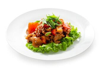 Pork in teriyaki sauce with pepper. Dish on a plate. Isolated.