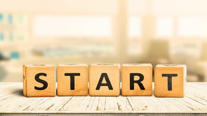 Start sign in a bright office on a wooden table.