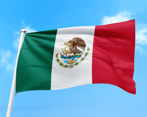 Mexico flag fluttering in the wind on sky.