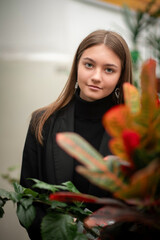 Portrait of a young beautiful long-haired girl in a public library.