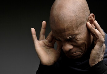 deafness suffering from hearing loss on grey black background with people stock image stock photo	