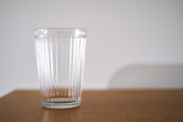 Minimalist Still Life: A Single Glass on a Wooden Table