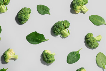 Composition with broccoli and spinach on light background