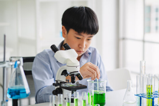 children using microscopes to study science at school