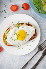 Delicious sandwich with fried egg on grunge background
