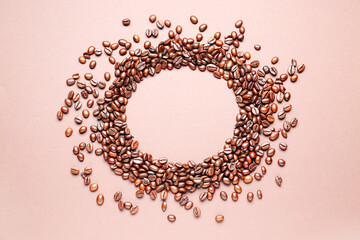 Frame made of coffee beans on beige background