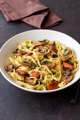 Tagliatelle pasta with mussels and mushrooms. Italian cuisine. Seafood.